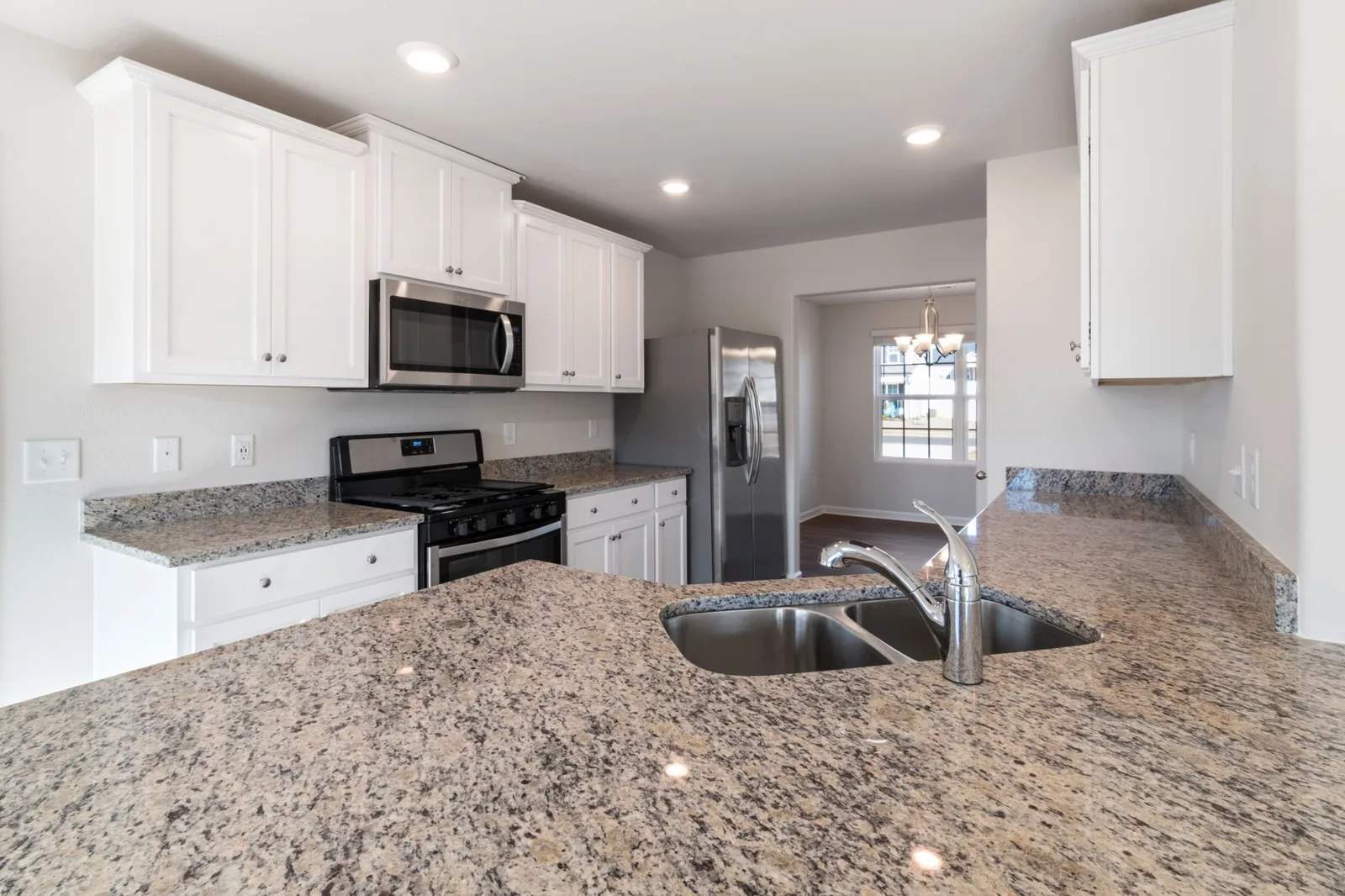 Granite vs quartz countertops side by side in a modern kitchen