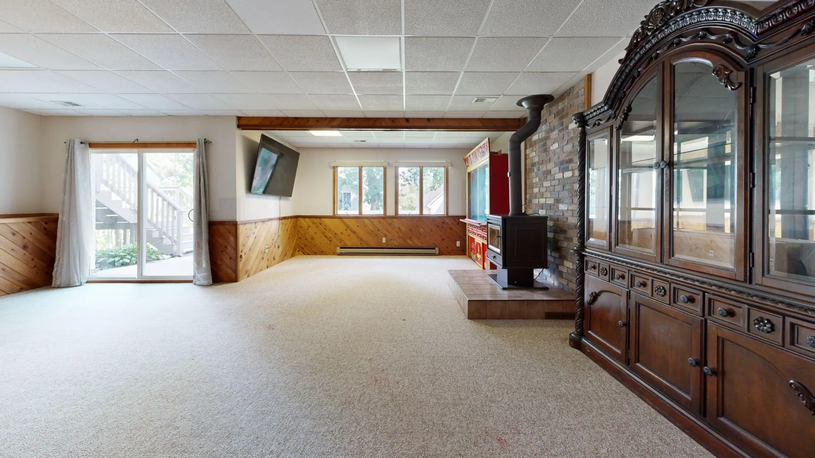 finished basement ideas — a finished basement family room with a sectional and built-in media wall
