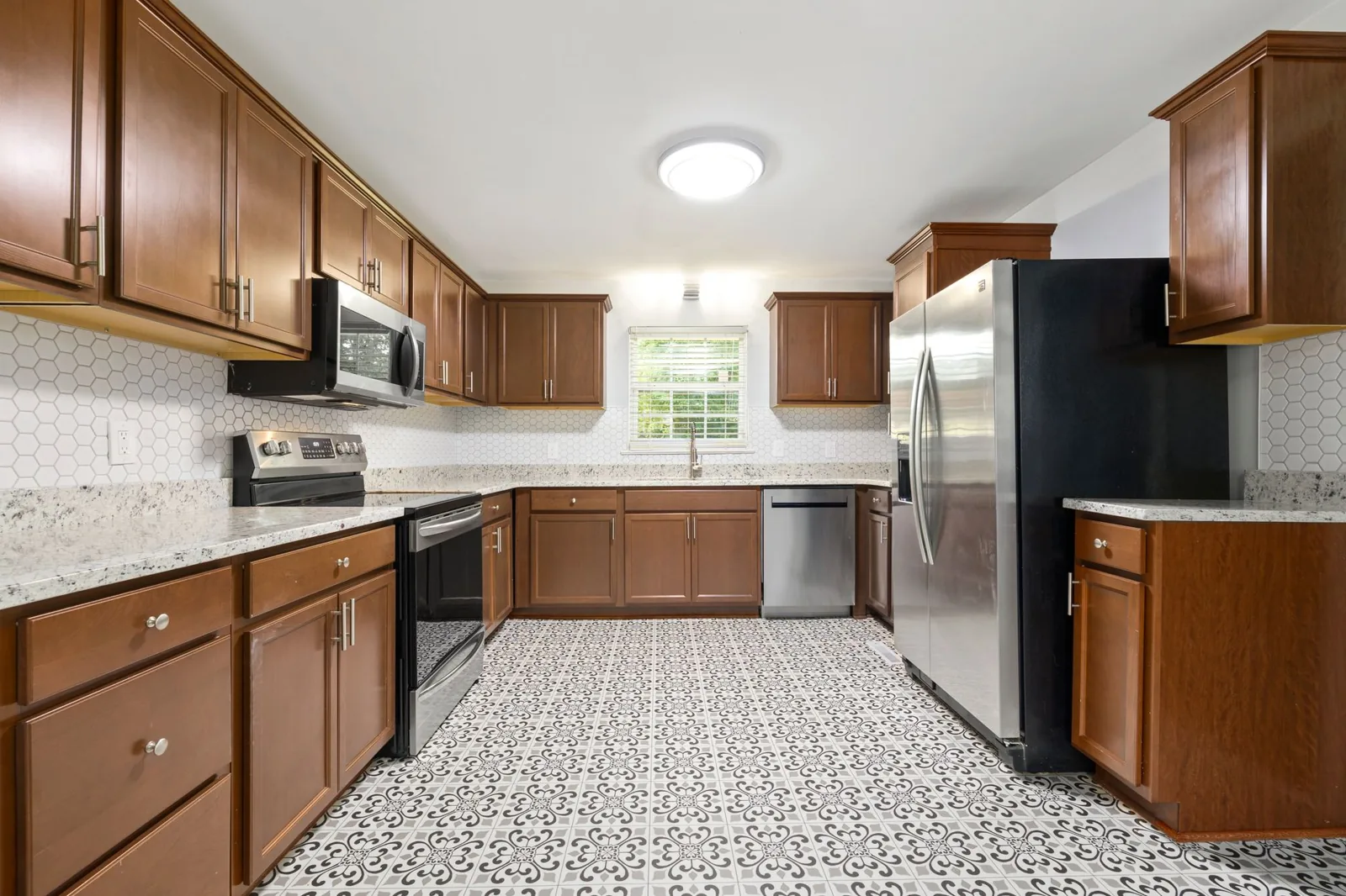 Budget kitchen remodel: refaced cabinets with new hardware and a subway tile backsplash