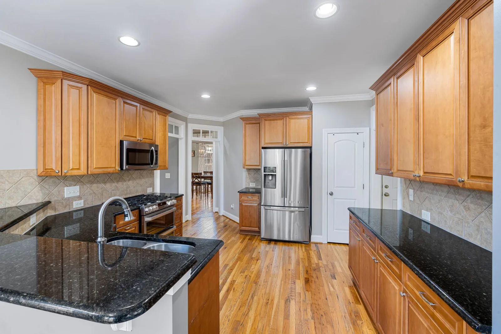 A renovated kitchen with refreshed cabinets, new countertops, and updated fixtures
