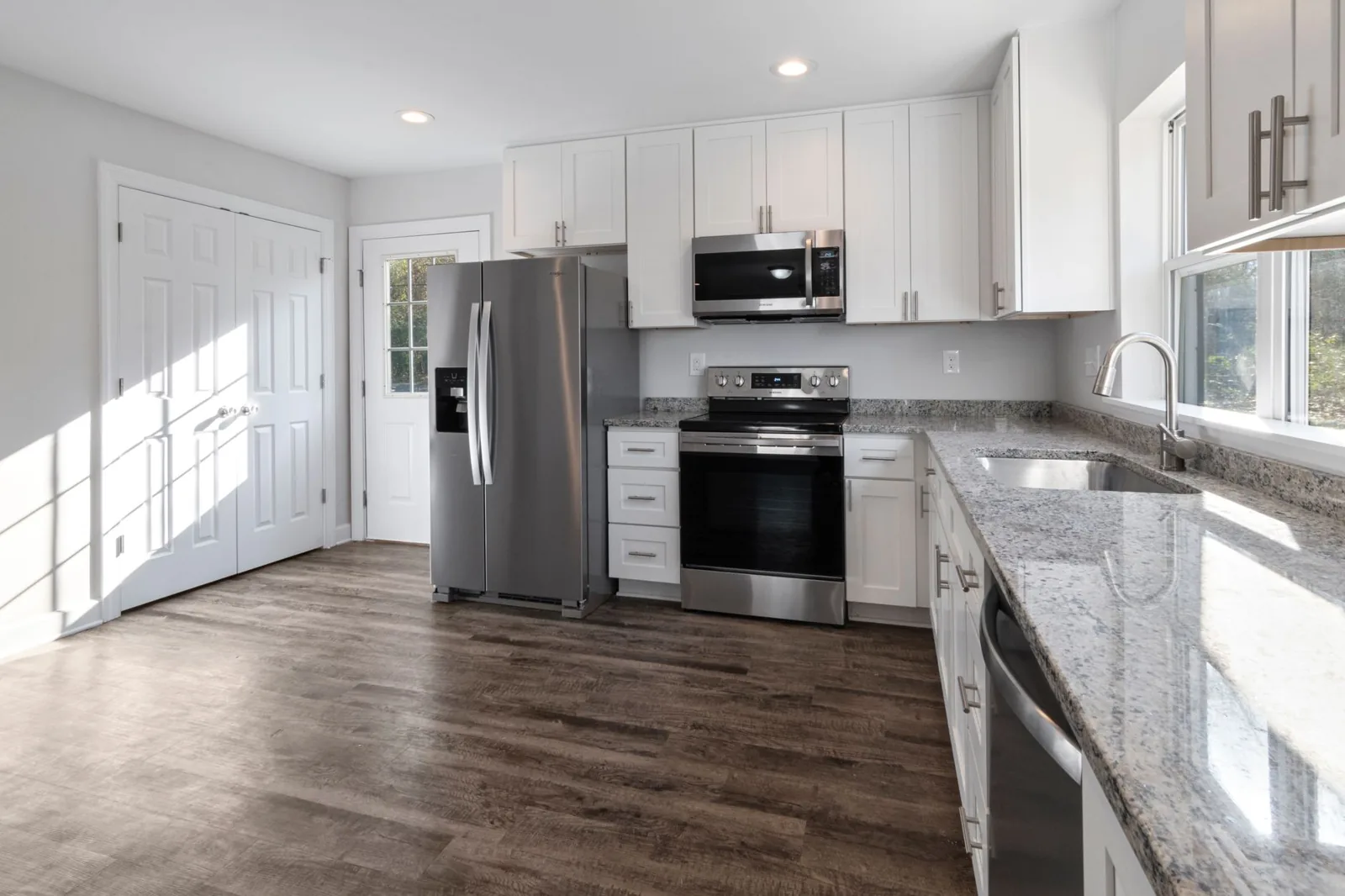 Newly renovated kitchen with quartz countertops and custom cabinetry