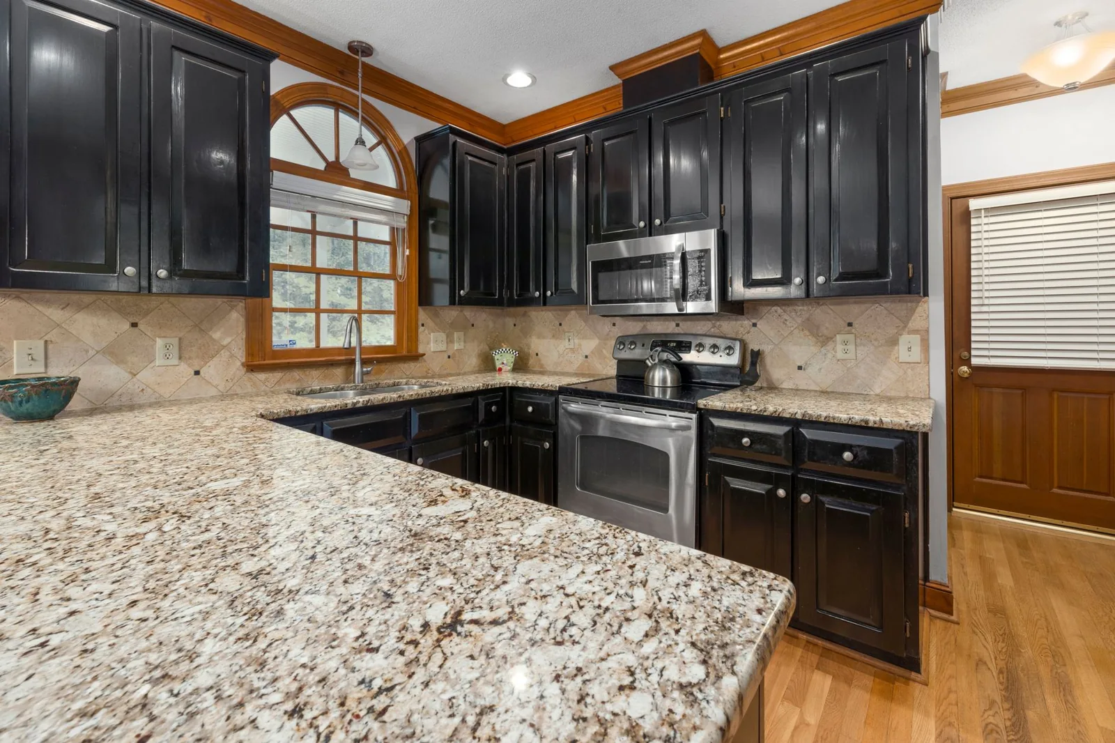Quartz countertop with clean veining in a white kitchen