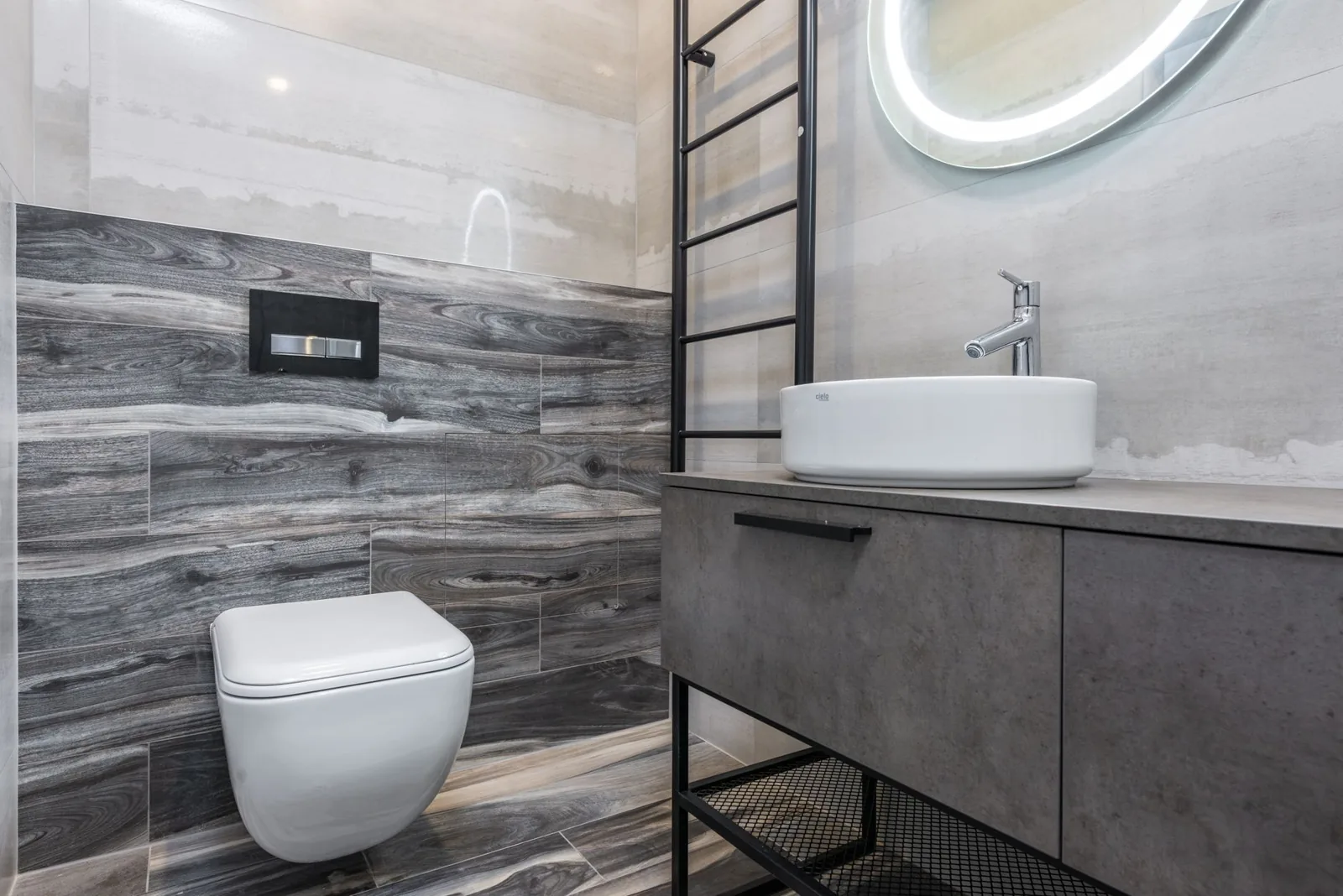 modern half bathroom with tile and floating vanity