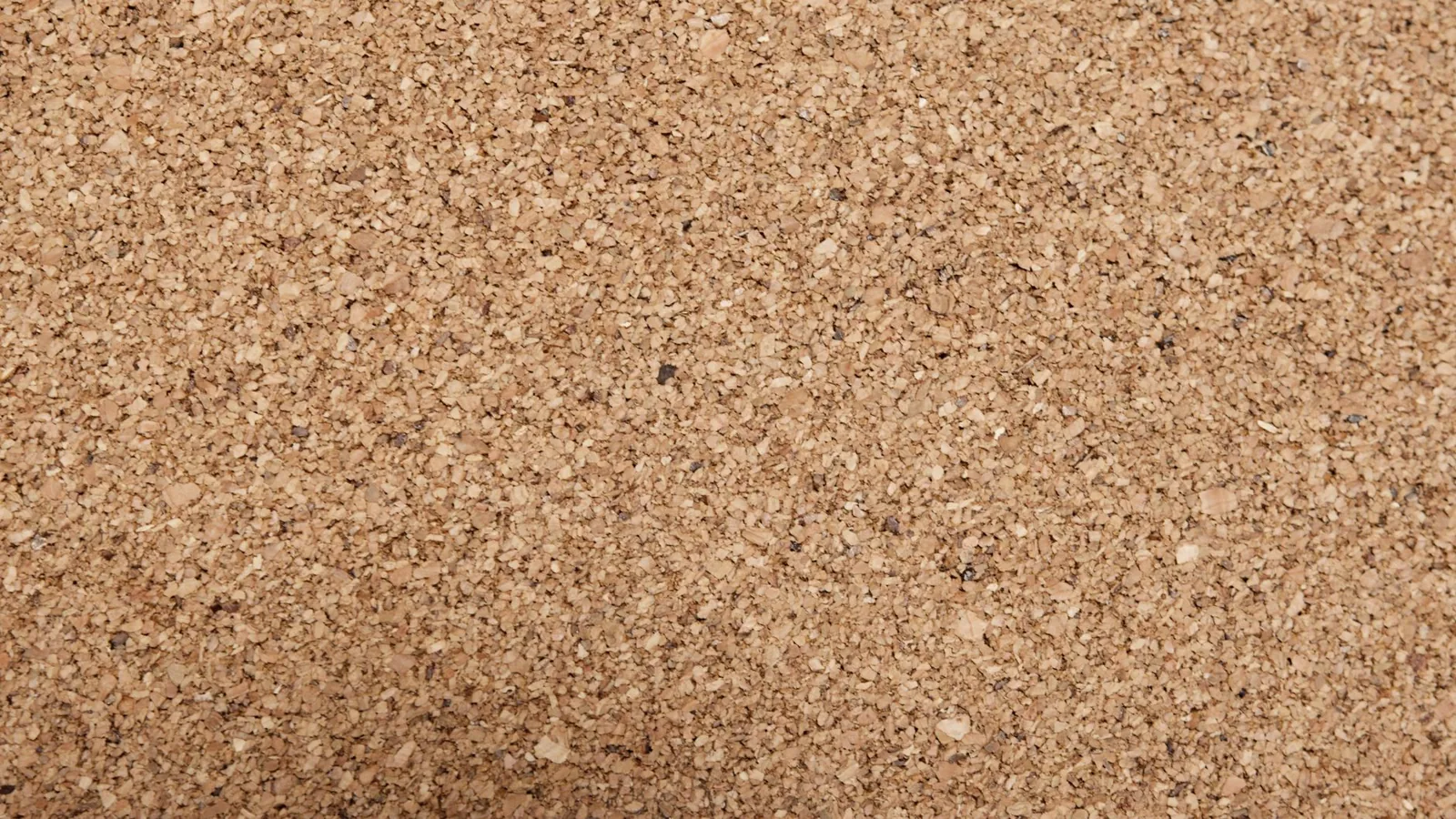Cellulose blown-in insulation being applied across an attic floor