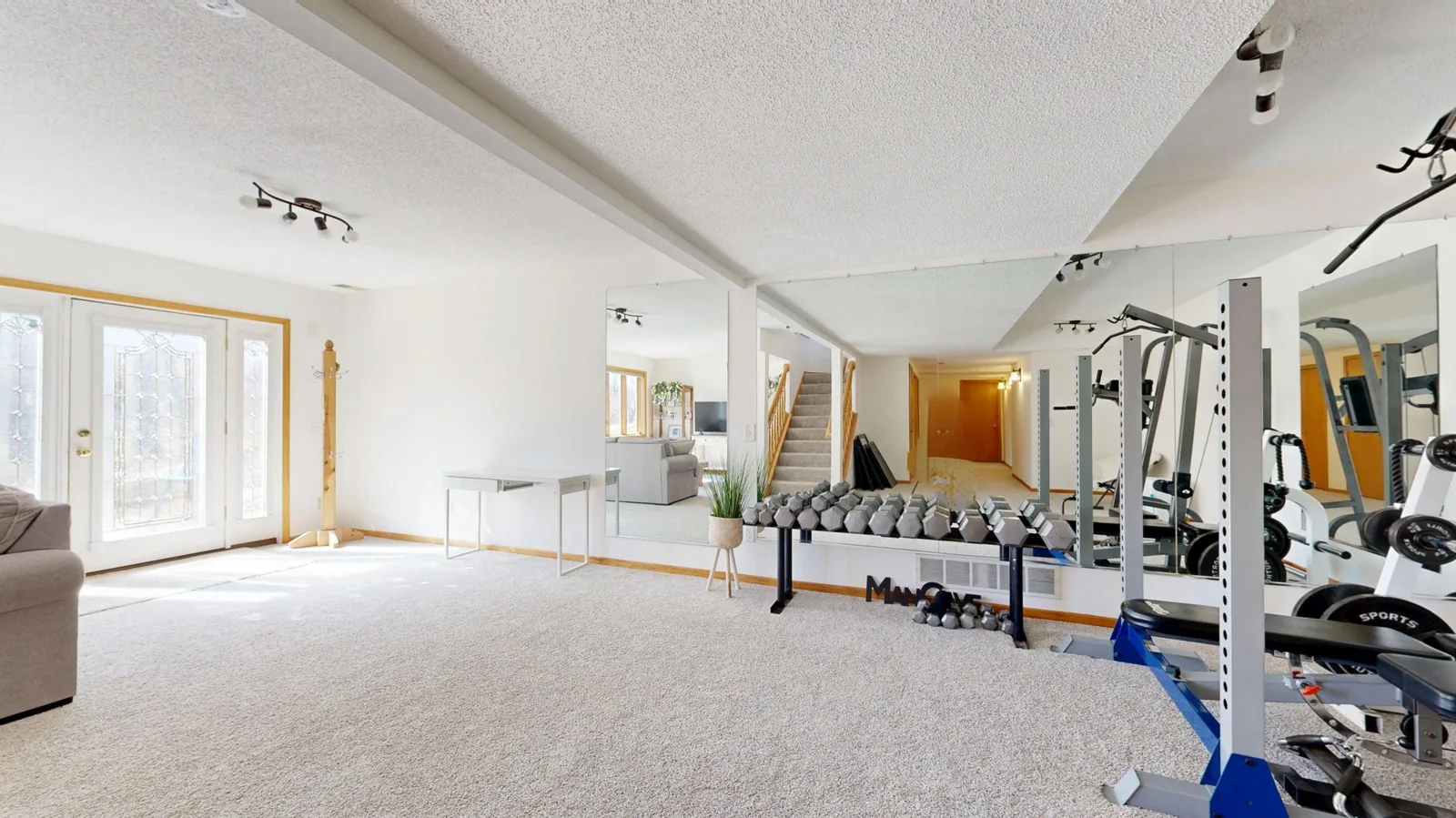 A finished basement guest bedroom with egress window and a bathroom beyond